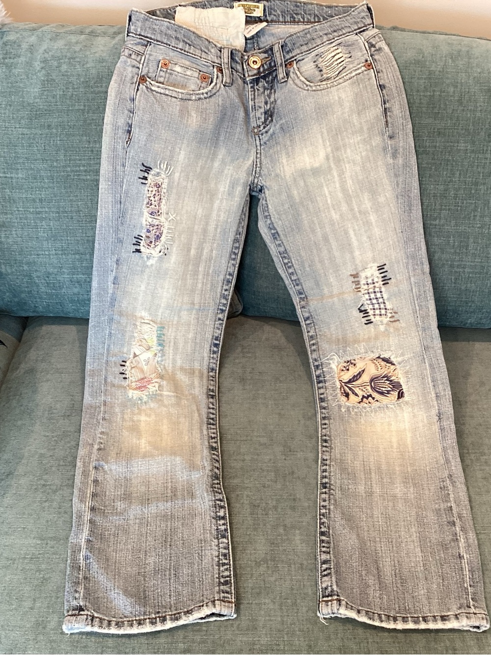 Light Blue Distressed Women's Jeans with Patch Details in a size 3.